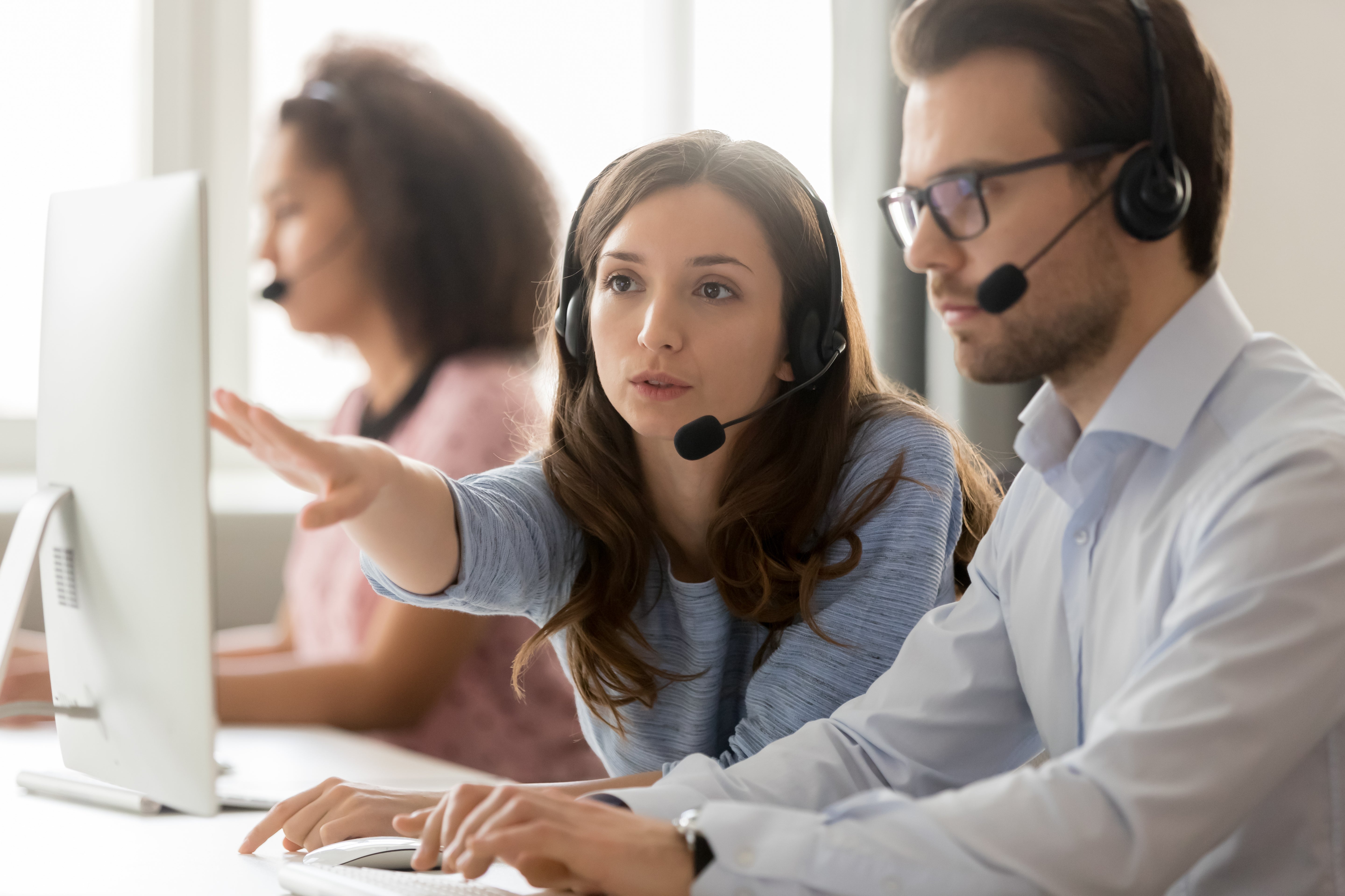 Two agents at private equity owned call center are discussing a matter