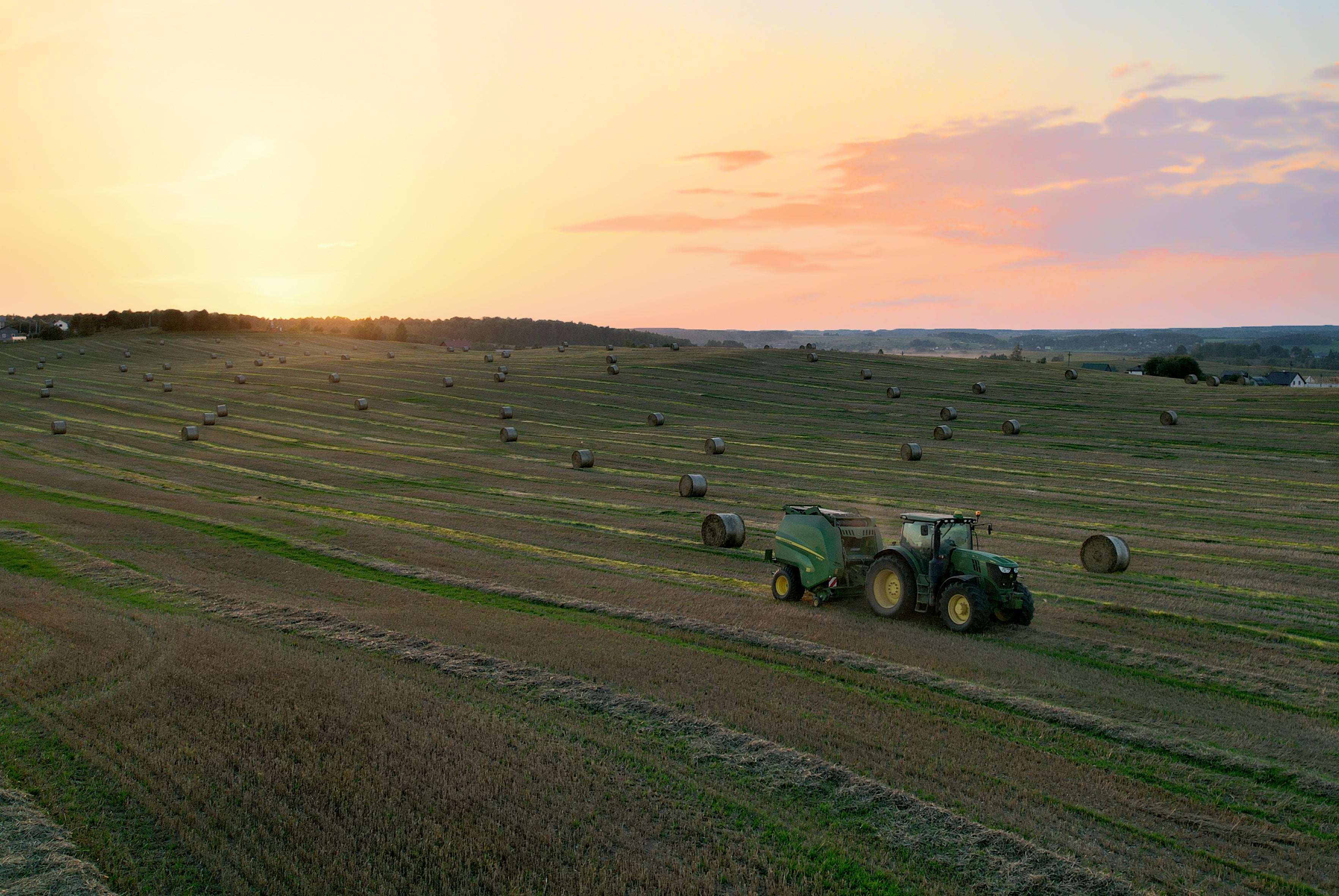 Farmer pulling a hay bale using private equity portfolio company component